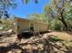 The home's backyard features an AC unit and mature trees at 40226 Palm St, Lady Lake, FL 32159