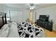 Bright bedroom with a ceiling fan, closet, and wooden floors at 40226 Palm St, Lady Lake, FL 32159