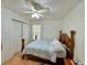 This bedroom includes a closet, ceiling fan and light wood floors at 40226 Palm St, Lady Lake, FL 32159