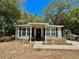 Charming single-story home with neutral siding, front seating, and decorative accents at 40226 Palm St, Lady Lake, FL 32159