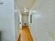 A clean hallway with wood floors leads to other rooms in the home at 40226 Palm St, Lady Lake, FL 32159