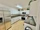 Kitchen with white cabinets and stainless steel appliances at 40226 Palm St, Lady Lake, FL 32159