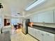 Open-concept kitchen with stainless steel appliances and views of the dining area at 40226 Palm St, Lady Lake, FL 32159