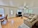Bright living room featuring a sectional sofa, wood-look flooring, and natural light at 40226 Palm St, Lady Lake, FL 32159