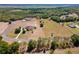Aerial view of an estate home with expansive acreage, mature trees, and manicured landscape at 41522 Saddle Ridge Ln, Weirsdale, FL 32195