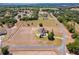 An aerial view of an estate home with sprawling acreage, mature trees, and well manicured grounds at 41522 Saddle Ridge Ln, Weirsdale, FL 32195