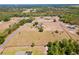 An aerial view of an estate home with sprawling acreage, mature trees, and well manicured grounds at 41522 Saddle Ridge Ln, Weirsdale, FL 32195
