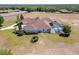 Aerial view of this home featuring a screened-in pool at 41522 Saddle Ridge Ln, Weirsdale, FL 32195