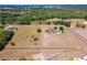 An aerial view of an estate home with sprawling acreage, mature trees, and well manicured grounds at 41522 Saddle Ridge Ln, Weirsdale, FL 32195