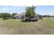 Spacious backyard featuring lush green grass and mature trees, enhancing the property's appeal at 41522 Saddle Ridge Ln, Weirsdale, FL 32195