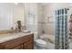 Well-lit bathroom features a tiled shower and granite countertop at 41522 Saddle Ridge Ln, Weirsdale, FL 32195