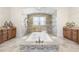 Luxurious bathroom with a soaking tub, dual vanities, and elegant tile work throughout at 41522 Saddle Ridge Ln, Weirsdale, FL 32195