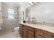 Bathroom with a glass-enclosed shower and granite vanity at 41522 Saddle Ridge Ln, Weirsdale, FL 32195