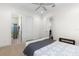 Clean bedroom featuring a bathroom entrance and modern ceiling fan at 41522 Saddle Ridge Ln, Weirsdale, FL 32195