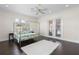 Bright bedroom features dark floors, a canopy bed, and pool access at 41522 Saddle Ridge Ln, Weirsdale, FL 32195