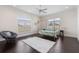 Bright bedroom features dark floors, a white rug, and outdoor views at 41522 Saddle Ridge Ln, Weirsdale, FL 32195