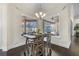 This dining area features views of the pool and covered patio at 41522 Saddle Ridge Ln, Weirsdale, FL 32195