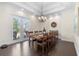 Dining room with tray ceiling, large window, and chandelier at 41522 Saddle Ridge Ln, Weirsdale, FL 32195