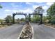 Grand gated entrance with a water feature, leading to a private and serene estate at 41522 Saddle Ridge Ln, Weirsdale, FL 32195
