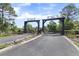 Private property gate with beautiful landscaping at 41522 Saddle Ridge Ln, Weirsdale, FL 32195