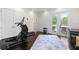 Bright exercise room with fitness equipment, dark floors, and an area rug for stretching and floor exercises at 41522 Saddle Ridge Ln, Weirsdale, FL 32195