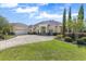 Beautiful home featuring well-manicured landscaping, a three-car garage, and a circular driveway at 41522 Saddle Ridge Ln, Weirsdale, FL 32195