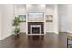 Elegant fireplace with marble hearth, flanked by paintings, and complemented by hardwood floors at 41522 Saddle Ridge Ln, Weirsdale, FL 32195