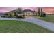 Stunning single-story home featuring well-manicured landscaping, a circular driveway, and a grand entrance at 41522 Saddle Ridge Ln, Weirsdale, FL 32195
