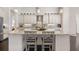 Well-appointed kitchen island features granite countertops, bar seating, and views of the breakfast room at 41522 Saddle Ridge Ln, Weirsdale, FL 32195