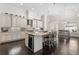 Gourmet kitchen with a large island, granite countertops, white cabinetry, and stainless steel appliances at 41522 Saddle Ridge Ln, Weirsdale, FL 32195