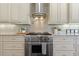 This kitchen features custom cabinets, stainless steel appliances, and granite countertops at 41522 Saddle Ridge Ln, Weirsdale, FL 32195