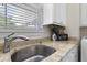Laundry room features stainless steel sink and a large window providing plenty of sunlight at 41522 Saddle Ridge Ln, Weirsdale, FL 32195