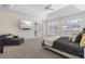 A main bedroom with carpeting has a four poster bed, television, and access to the outside patio at 41522 Saddle Ridge Ln, Weirsdale, FL 32195