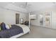 A large main bedroom has beautiful lighting, a sitting area, and doors leading to the outside patio at 41522 Saddle Ridge Ln, Weirsdale, FL 32195