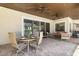 A covered patio has seating and dining areas and provides a view of the screened pool area at 41522 Saddle Ridge Ln, Weirsdale, FL 32195