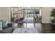 A view from inside of the home through sliding glass doors to the outdoor patio, pool, and entertaining space at 41522 Saddle Ridge Ln, Weirsdale, FL 32195