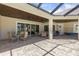 A covered patio has chairs and tables, ceiling fans, and is screened in for relaxing outside the home at 41522 Saddle Ridge Ln, Weirsdale, FL 32195