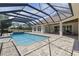 A screened pool and patio are part of the beautiful backyard for this home with a pool and spa at 41522 Saddle Ridge Ln, Weirsdale, FL 32195