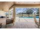 A screened pool area has a beautiful view of the backyard and a peek inside the covered patio area at 41522 Saddle Ridge Ln, Weirsdale, FL 32195
