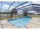 A stunning screened-in pool with a hot tub and brick surround provides a relaxing outdoor experience at 41522 Saddle Ridge Ln, Weirsdale, FL 32195