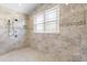 Walk-in shower detailed with mosaic tile accents and a window for natural lighting at 41522 Saddle Ridge Ln, Weirsdale, FL 32195