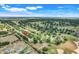 Beautiful aerial view of a neighborhood on a golf course with mature trees and green lawns on a sunny day at 4167 Capland Ave, Clermont, FL 34711