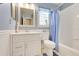 Blue bathroom featuring a vanity, mirror, updated sink and faucets, and toilet at 4167 Capland Ave, Clermont, FL 34711