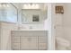 Bathroom featuring a vanity, mirror, updated sink and faucets, and toilet at 4167 Capland Ave, Clermont, FL 34711