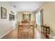Dining room features wood floors, large china cabinet, chandelier and natural light from a nearby window at 4167 Capland Ave, Clermont, FL 34711