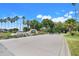 Wide view of the Kings Ridge community entrance with palm trees and manicured grounds at 4167 Capland Ave, Clermont, FL 34711