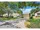 Lovely single-story home featuring a manicured lawn, mature trees, and a spacious two-car garage at 4167 Capland Ave, Clermont, FL 34711