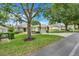 Beautiful single-story home with a landscaped front yard, mature trees, and a convenient two-car garage at 4167 Capland Ave, Clermont, FL 34711