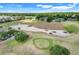 A picturesque aerial view of the golf course including sand traps and putting green at 4167 Capland Ave, Clermont, FL 34711