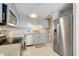 Bright kitchen with white cabinets, stainless steel appliances, granite counters, and mosaic tile backsplash at 4167 Capland Ave, Clermont, FL 34711